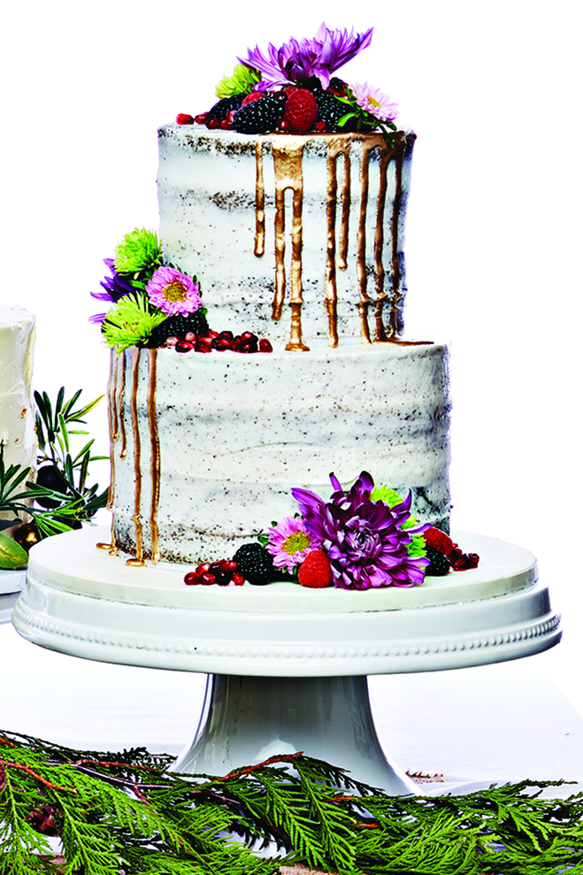 A two-tiered devil's food cake with raspberries, blackberries and pomegranate seeds from Miss Sara's Cakery.